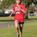 Logan Badura places fourth in the eighth-grade girls race Wednesday. (Photo by John Fisken)