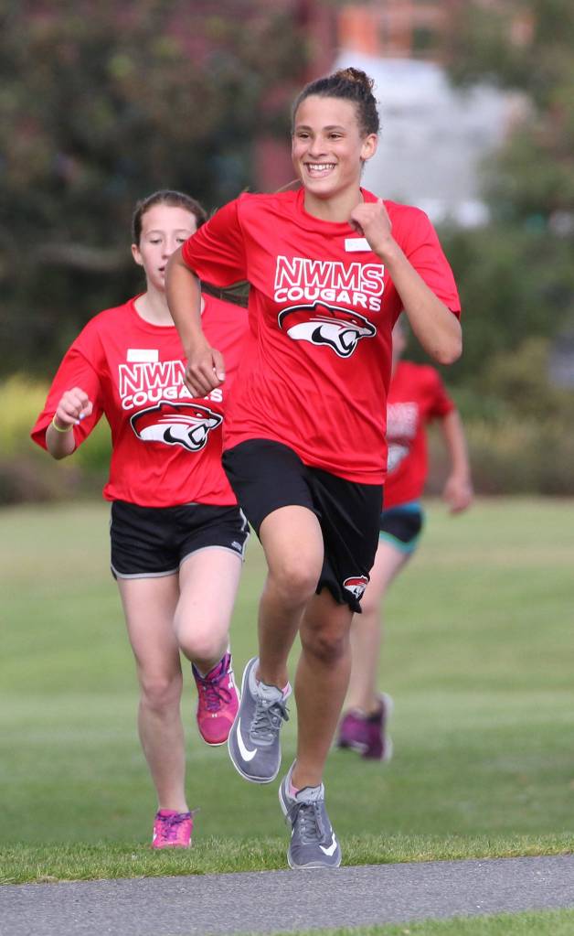 Jada Miller leads a string of North Whidbey runners who place sixth through ninth in the seventh-grade girls race. (Photo by John Fisken)