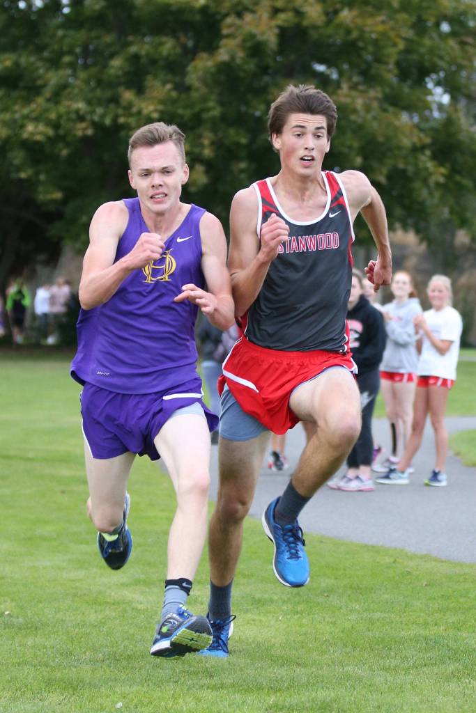 Oak Harbor&rsquo;s Micah Franklin, left, battles Stanwood&rsquo;s Garrett Larson as they near the finish line. (Photo by John Fisken)