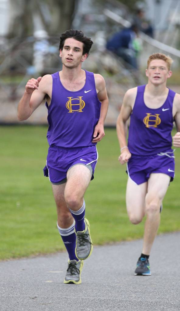 Oak Harbor&rsquo;s Tyler Grehan and Dallas Riddle-Stevens run mid-course in the boys race. Riddle-Stevens eventually finished second and Grehan fourth. (Photo by John Fisken)