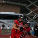 Hunter Downes tosses a pass while Chris Battaglia prepares to block. (Photo by Jim Waller/Whidbey News-Times)