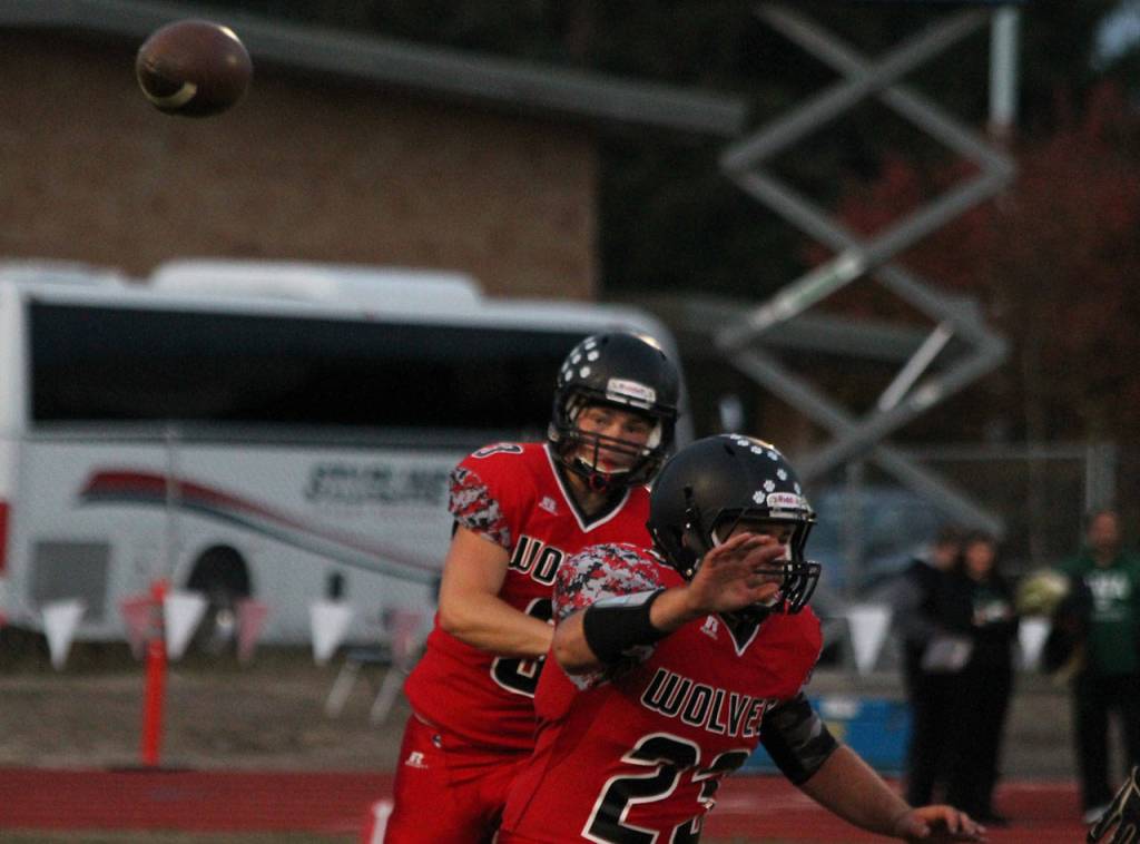 Hunter Downes tosses a pass while Chris Battaglia prepares to block. (Photo by Jim Waller/Whidbey News-Times)