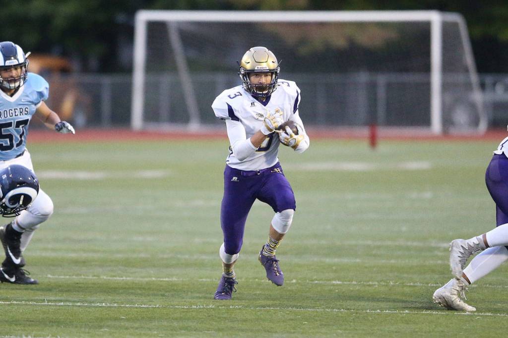Andrew Miller zips through a huge hole in the Rogers&rsquo; defense. (Photo by John Fisken)