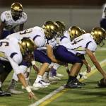 The Oak Harbor offensive line prepares to fire off the ball against Rogers Friday. The line helped the Wildcats pile up nearly 400 yards of offense. (Photo by John Fisken)