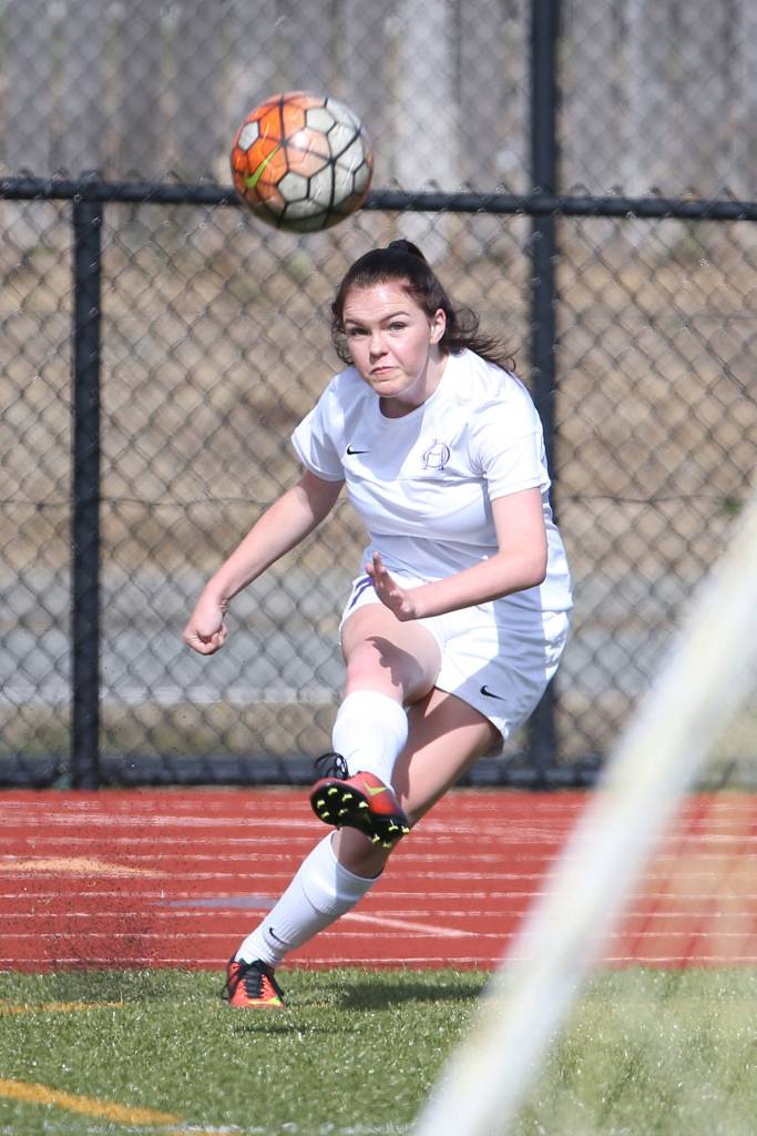 Gracie Hiteshew delivers a corner kick for Oak Harbor. (Photo by John Fisken)
