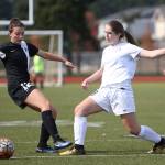 Peyton Rhyne and South Whidbey&rsquo;s Karyna Hezel (12) battle for control of the ball. (Photo by John Fisken)