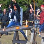Tamika Nastali, left, cheers as Madison Rixe successfully sinks a pumpkin in the &ldquo;pool&rdquo; leg of the relay. The girls were part of the Coupeville High School drama troupe that won for having the fastest relay time. Photo by Megan Hansen/Whidbey News-Times.