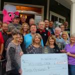 Pigfest organizers presented a $20,000 check to Help House and CADA Friday at a gathering of about 25 sponsors. Accepting the check is Cynde Robinson (left) director of CADA and Jean Wieman, director of Help House. Money raised at the annual free summer event comes from crowd donations.                                Photo by Patricia Guthrie/Whidbey News-Times