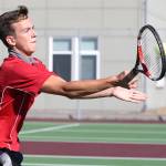 Coupeville&rsquo;s Nick Etzell returns a shot in his second doubles win with partner Mason Grove. (Photo by John Fisken)