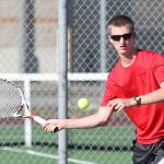 The Wolves&rsquo; Jakobi Baumann swats a shot in his sweep of second singles. (Photo by John Fisken)