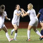 Oak Harbor&rsquo;s Jenna Cooley, center, is congratulated on her goal by Caylie Etherington (11) as Aidan Anderson (5) runs to join the celebration. Etherington assisted on the goal. Everett&rsquo;s Kelsey Price (12) isn&rsquo;t so happy. (Photo by John Fisken)