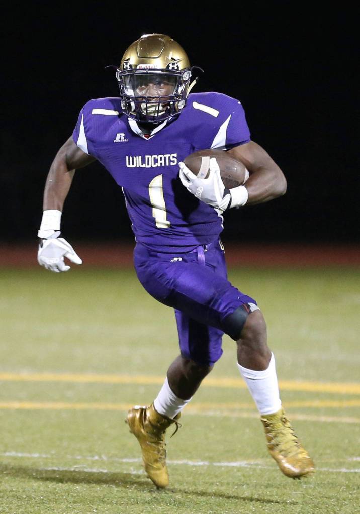 Taeson Hardin sprints around the end for a chunk of yardage.(Photo by John Fisken)