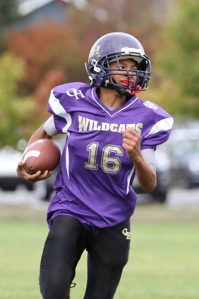 Oak Harbor Junior Ezra Kitchens looks for running room.(Photo by John Fisken)