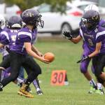 Oak Harbor Midget quarterback Connor Cash hands off to Jacob Espinoza.(Photo by John Fisken)