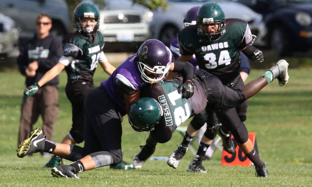 Oak Harbor Senior Nolan Byng brings down a Mount Vernon runner.(Photo by John Fisken)