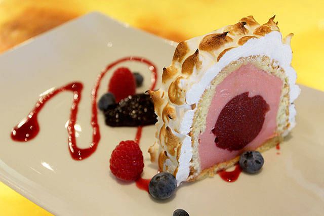 This Baked Alaska is a many-layered wonder of sponge cake, rhubarb sherbet, blueberry sorbet center, toasted meringue and swirls of raspberry.