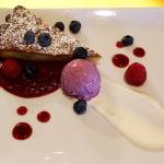 Almond cake, featuring blueberry ice cream and strawberry jam.