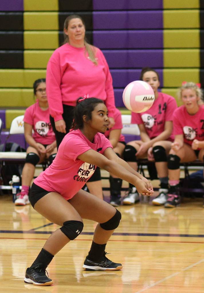 Jaslin Webster passes as coach Kerri Molitor and the Wildcat bench looks on.(Photo by John Fisken)