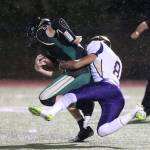 Darian Matsushita tackles Marysville Getchell quarterback Caleb Koellmer. Matshuita and the Wildcat defense limited the Chargers to only 104 yards of offense.(Photo by John Fisken)