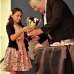 Haley Borja, left, accepts the trophy as NWAC&rsquo;s Swimmer of the Year for 2016-17 from coach Dick Taylor at their recent awards banquet. Borja opened the 2017-18 season with eight wins. (submitted photo)