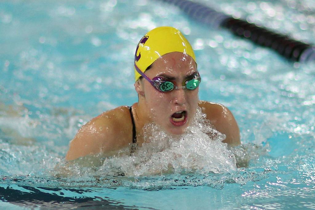 Senior Taliah Black swims to second place in the 100 breaststroke. (Photo by John Fisken)