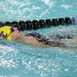 Senior Scout Powell glides to third place in the 100-meter backstroke.(Photo by John Fisken)