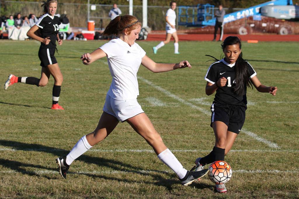 Coupeville&rsquo;s Ema Smith beats Sequim&rsquo;s Kristina Mingoy (14) to the ball.(Photo by John Fisken)