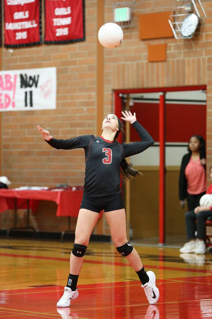 Maya Toomey-Stout serves against Sequim Tuesday.(Photo by John Fisken)