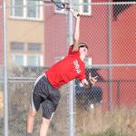 Jakobi Baumann unleashes a serves against Sequim.(Photo by John Fisken)