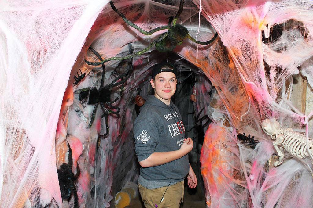 Tyler Boyle, aka Mr. Giggles Jr., gives a tour before the lights go out at Frightville, an annual fundraiser for the Boys and Girls Club of Oak Harbor. About three dozen volunteers worked for weeks on creating fear factor fun.
