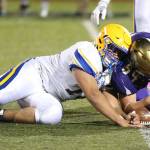 Michael Fisken, right, out-wrestles a Ferndale player for a fumble recovery.(Photo by John Fisken)