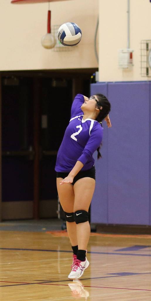 Sherilyne Fernandez puts the ball in play for Oak Harbor.(Photo by John Fisken)