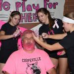 Katrina McGranahan, left, Emma Smith and Lauren Rose help John Fisken get all pinked up.