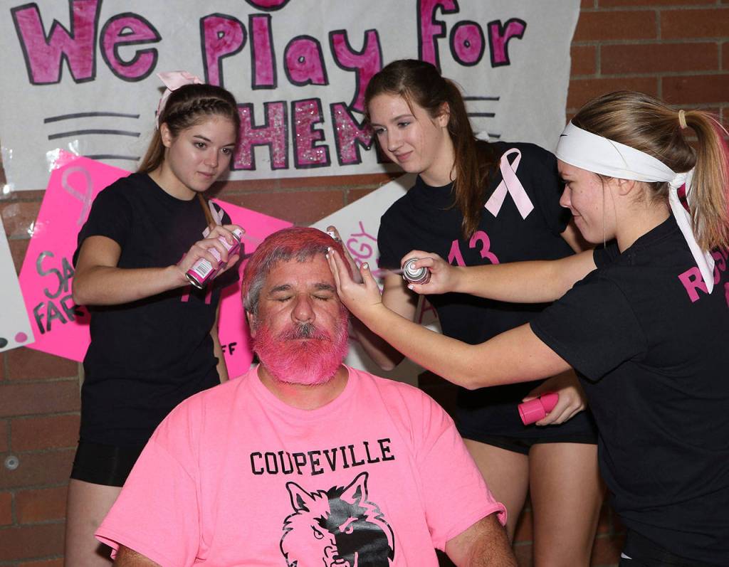 Katrina McGranahan, left, Emma Smith and Lauren Rose help John Fisken get all pinked up.