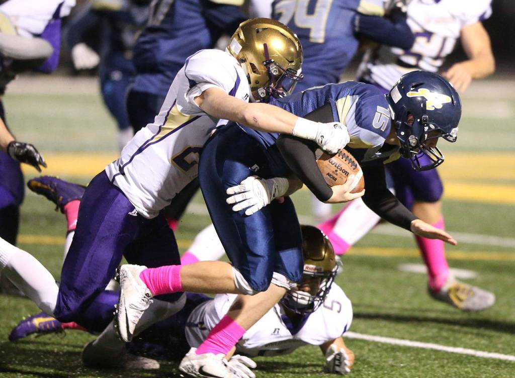 Calvin Whelpley brings down Arlington&rsquo;s Kirahy Meyers.Photo by John Fisken