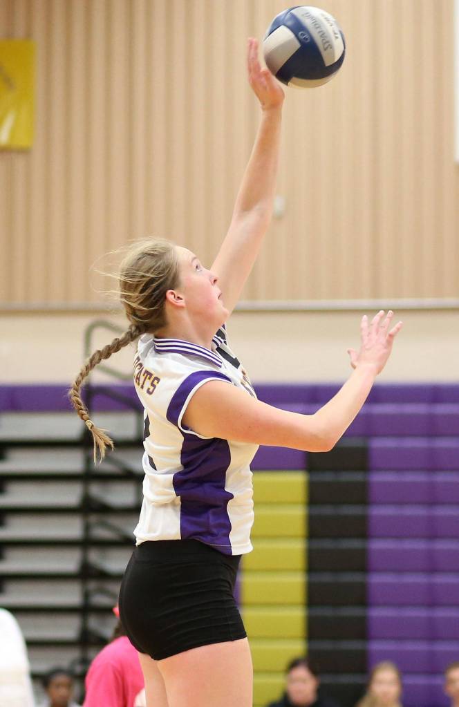 Hailee Blau attacks from the back row for the Wildcats. (Photo by John Fisken)