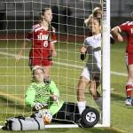 Lenika Aguilar (white jersey) watches as Caylie Etherington&rsquo;s shot slips in for a goal.(Photo by John Fisken)