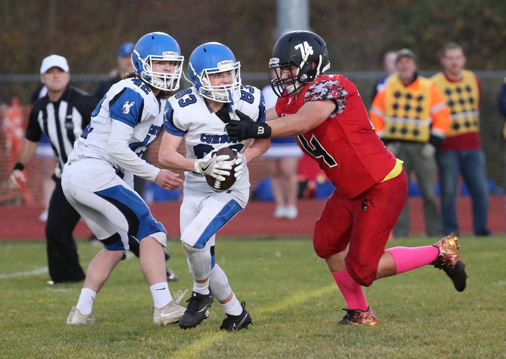 Tyler McClamont brings down Chimacum&rsquo;s Isaac Purser.(Photo by John Fisken)
