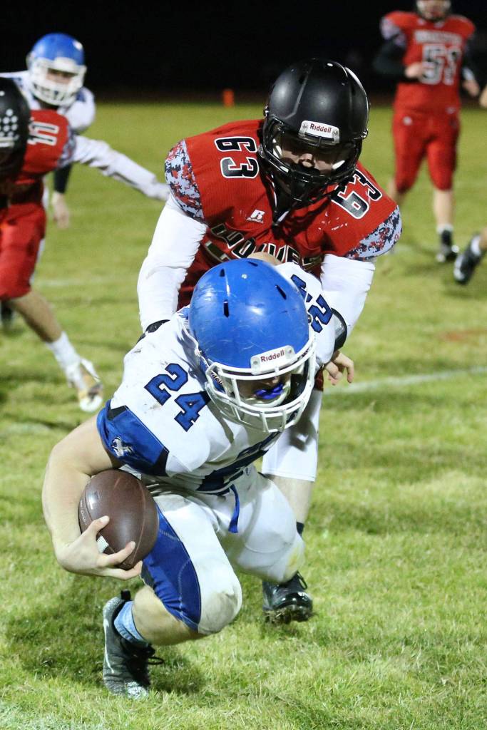 Kyle Rockwell tackles Chimacum&rsquo;s Ryan Caldwell.(Photo by John Fisken)