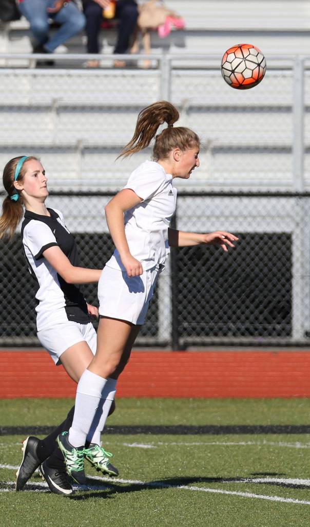 Tia Wurzrainer advances the ball for Coupeville with a header.(Photo by John Fisken)
