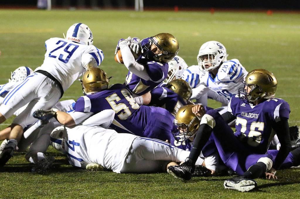 Above: Aaron Martinez punches the ball in from the 1-yard line for a Wildcat touchdown. Below: Martinez fumbled the ball after breaking the plane and Ozell Jackson (76) recovers.(Photos by John Fisken)