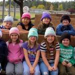 Neighborhood knitter makes hats for classroom