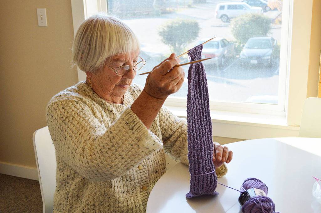 Dorothy Bell works on a scarf she is knitting. Bell used her skills to knit hats for an entire third-grade class at Crescent Harbor Elementary. Photo by Laura Guido/Whidbey News-Times