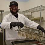 Kyle Jensen / The Record  Whidbey Island Ice Cream employee Joe Valencia prepares to put sticks in the companys ice cream bars before they freeze.