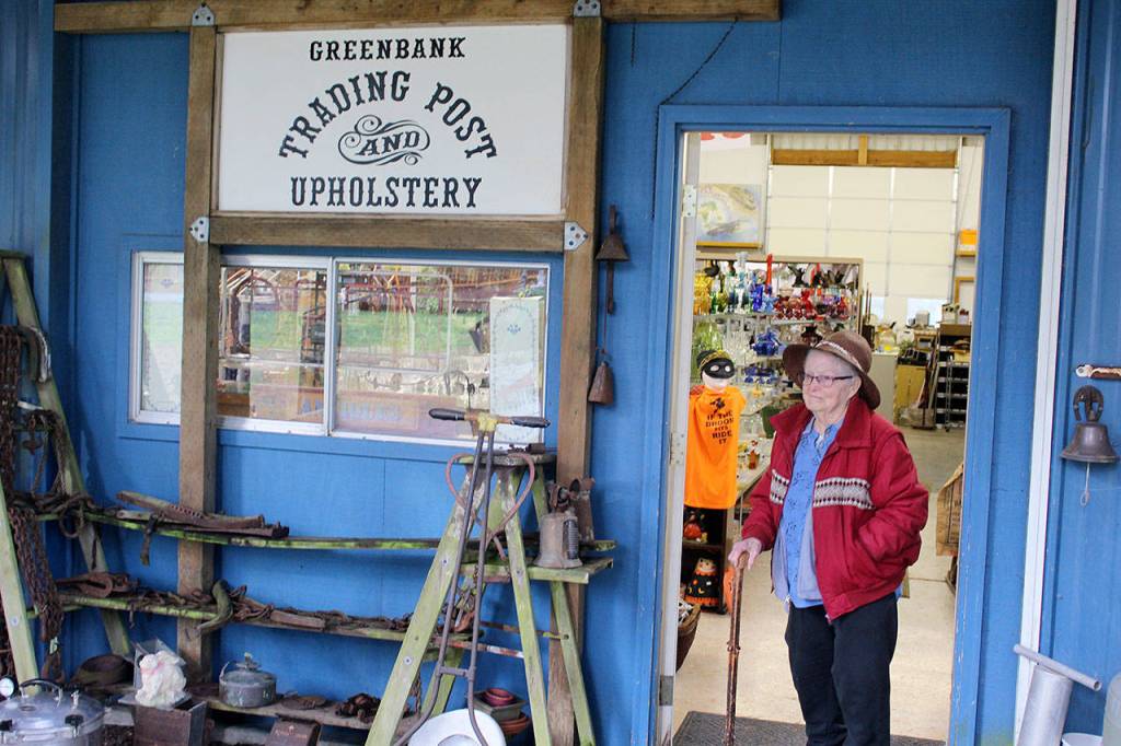 RuthAnne Gatto walks outside the entrance to Greenbank Trading Post, located next to Greenbank Progressive Hall on Bakken Road.