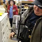 Anthony Gatto looks over a contraption of old with an unknown purpose. Its a huge jar with a hose underneath the bottle. For taking blood? Wine-making? Old bubble maker? Moonshine?