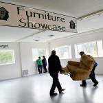 Jeff Humphrey and John Weatherford carry in the first furniture donations to Garage of Blessings in Oak Harbor. The organization now has space for them thanks to a gift from Mike Rowe, of Dirty Jobs, and his new show Returning the Favor. In the background, founder and owner Kristiina Miller, and volunteer Annette Jones, enjoy the new windowssomething else the garage has never had. Photo by Laura Guido/Whidbey News-Times