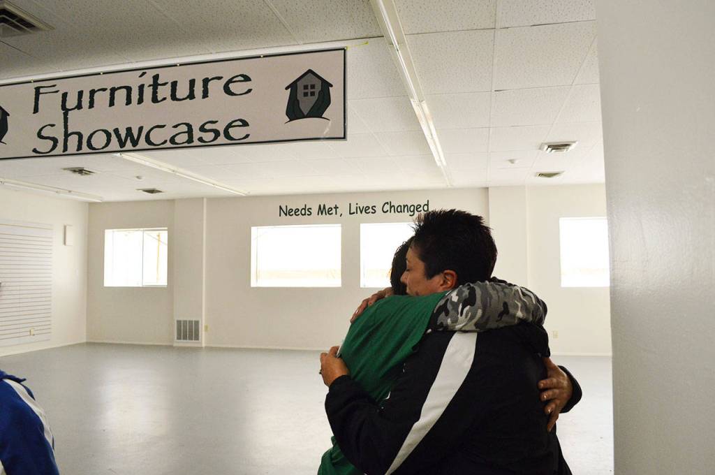 Garage of Blessings volunteer Annette Jones hugs founder and owner Kristiina Miller in the organizations new space. Mike Rowe, of Dirty Jobs, and his new Facebook show Returning the Favor, organized the expansion and renovation of the building as a surprise to Miller. Photo by Laura Guido/Whidbey News-Times