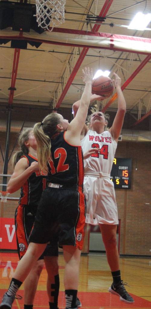 Lindsey Roberts powers a shot up over Blaines Tayluyn DePauw.(Photo by Jim Waller/Whidbey News-Times)