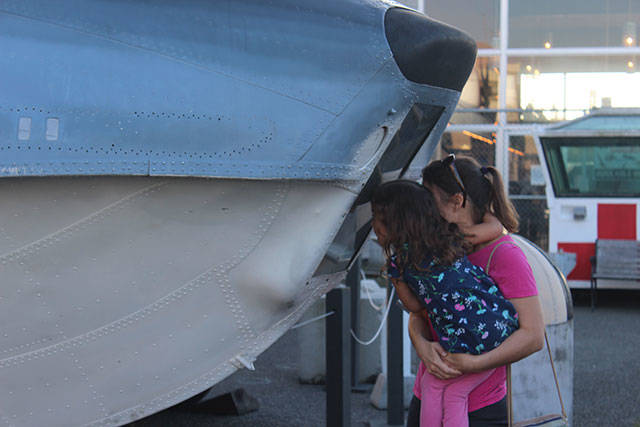 Jennifer Zovar peeks into float space of the seaplane with her daughter Helen. They visited Veterans Day weekend from Bellingham.                                Photo by Patricia Guthrie/Whidbey News-Times